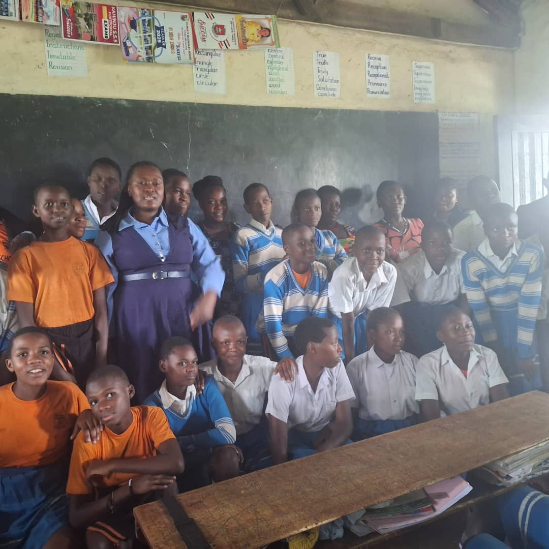 Young Ugandan children smiling in a community setting, representing the future BPF is building
